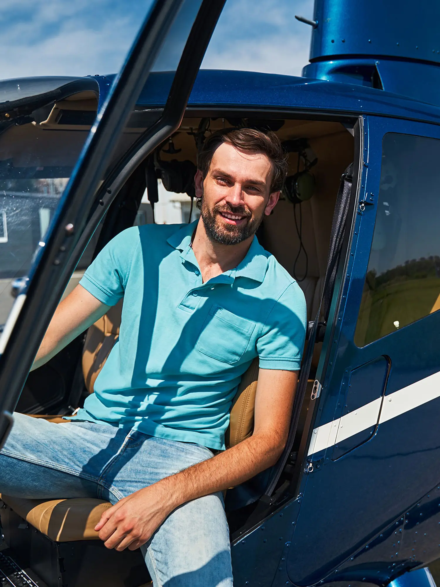 happy-male-pilot-posing-for-camera-before-helicopter.jpg