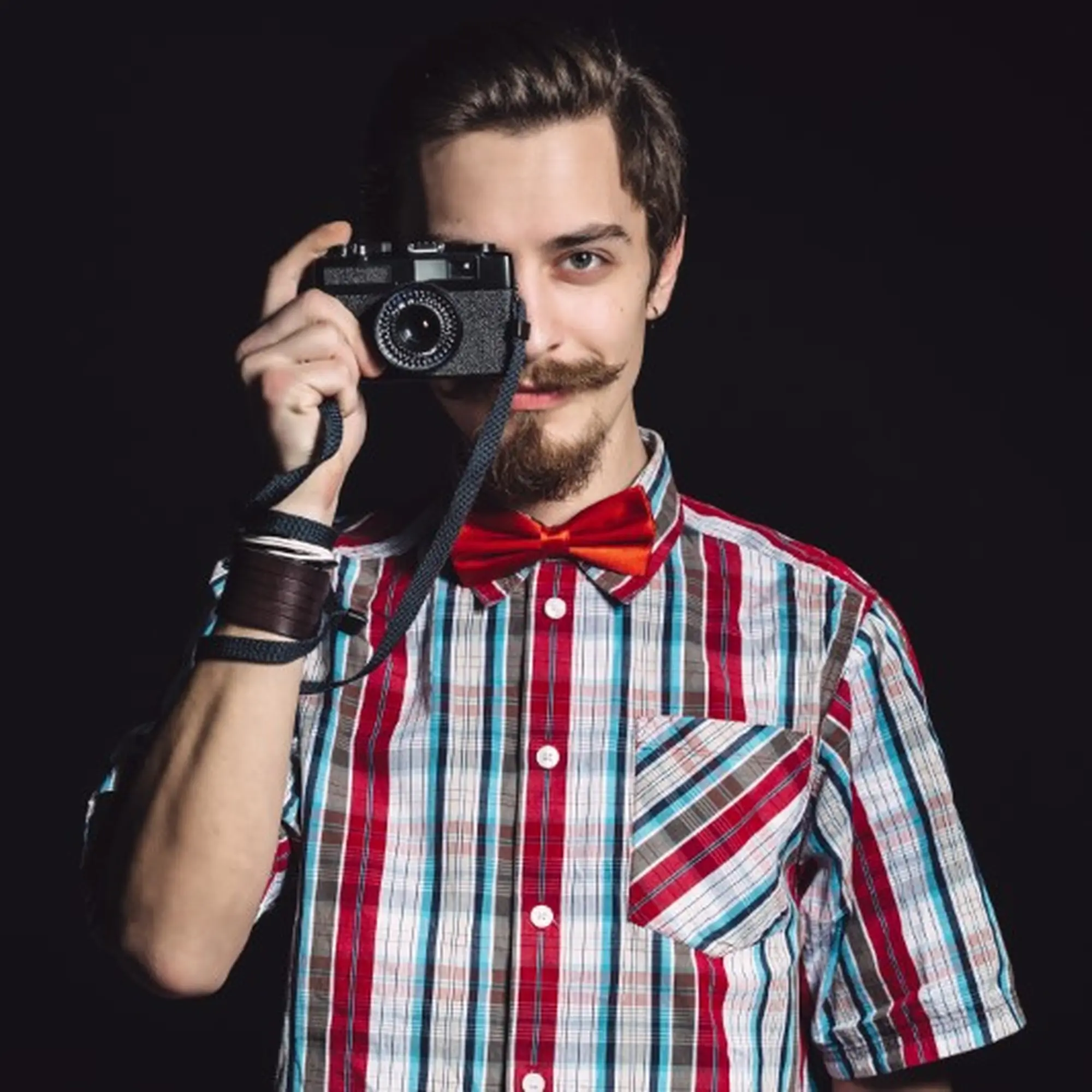 portrait-of-a-cheerful-photographer-in-studio-PRHG57X-Custom.jpg