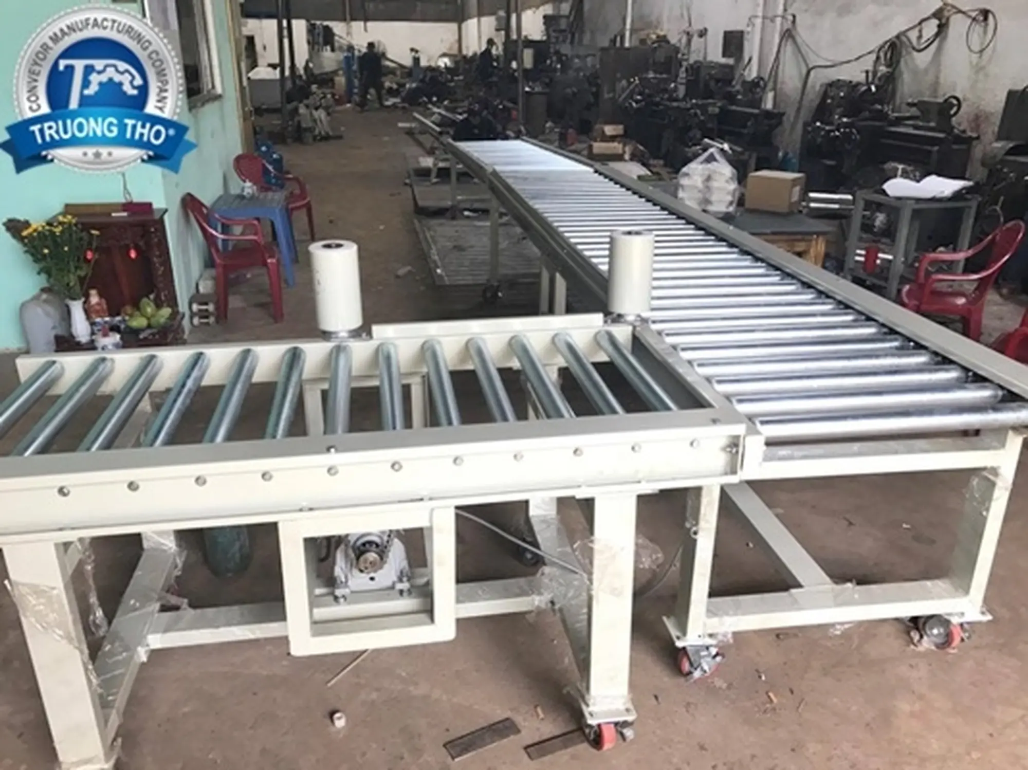 Băng tải con lăn truyền động xích