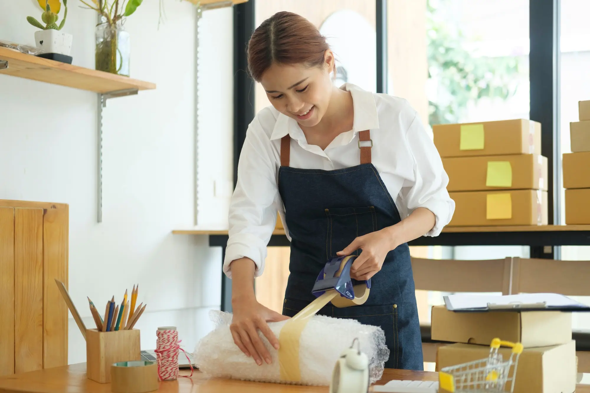 female-online-business-owner-packing-order-box-for-dispatching-.jpg